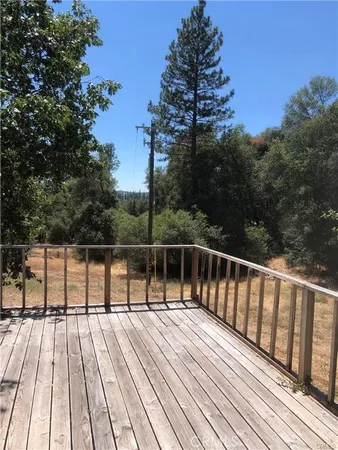 a view of balcony with wooden floor and fence