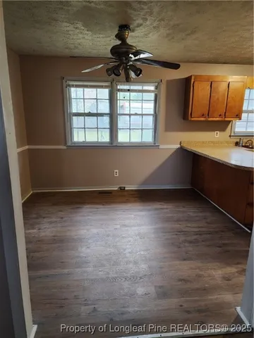 a kitchen with stainless steel appliances granite countertop a sink a stove and a microwave