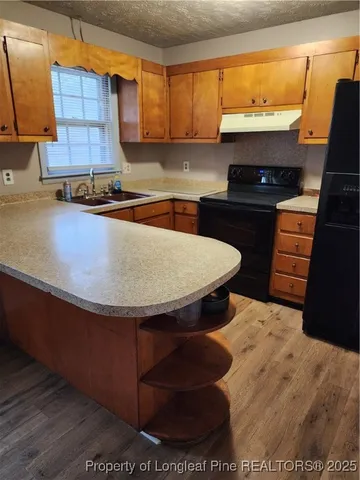 a kitchen with stainless steel appliances wooden cabinets and a sink