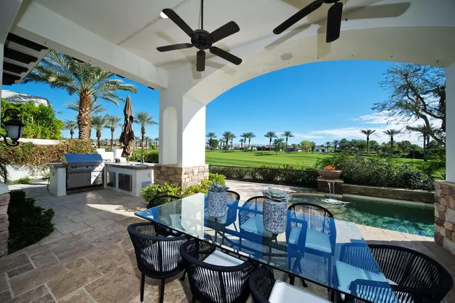 a outdoor living space with furniture potted plant and a lamp