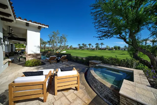 a large kitchen with stainless steel appliances kitchen island granite countertop a large kitchen island a stove a sink a dining table and chairs