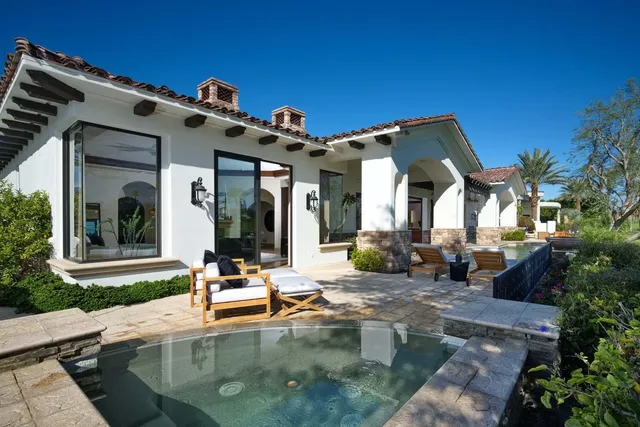 a large spacious bathroom with a double vanity sink a large mirror and a bathtub
