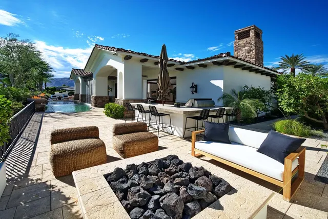 a living room with furniture fireplace and a large window