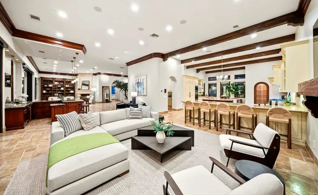a living room with furniture a fireplace and a floor to ceiling window