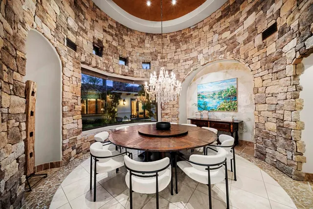 a bedroom with a bed a ceiling fan and a rug