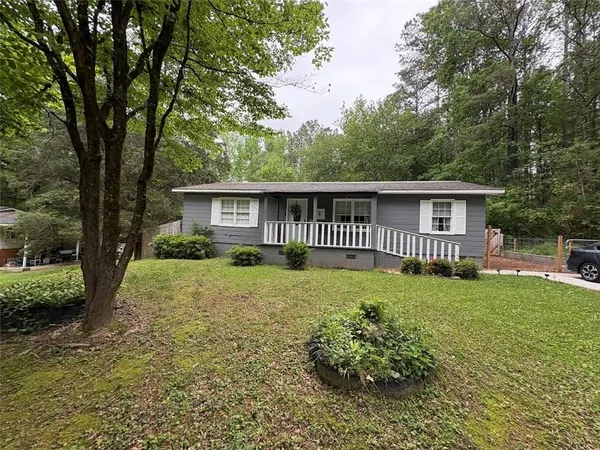 a view of a house with a yard and a garden