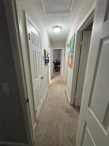 a view of a hallway with windows and stairs