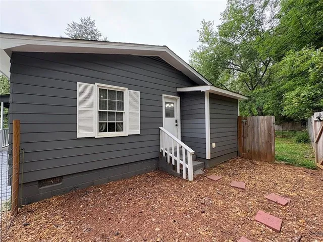 a back view of a house with a yard