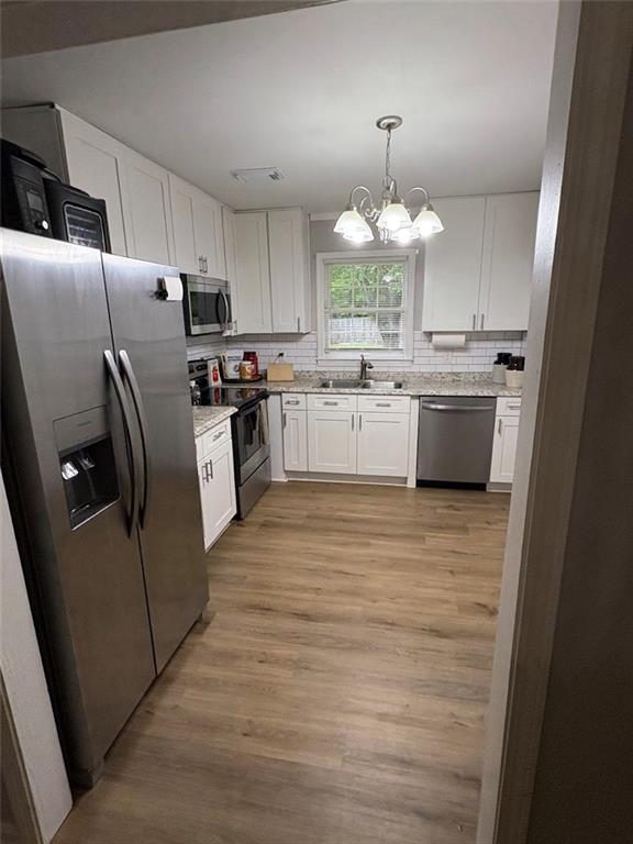 38 Daniel Circle Franklin, GA 30217 - Photo 10 of 27 a kitchen with stainless steel appliances a refrigerator sink and wooden cabinets