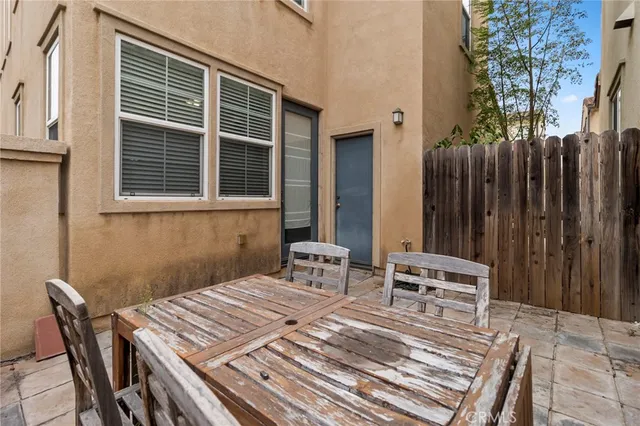 a view of a dinning table and chairs in patio
