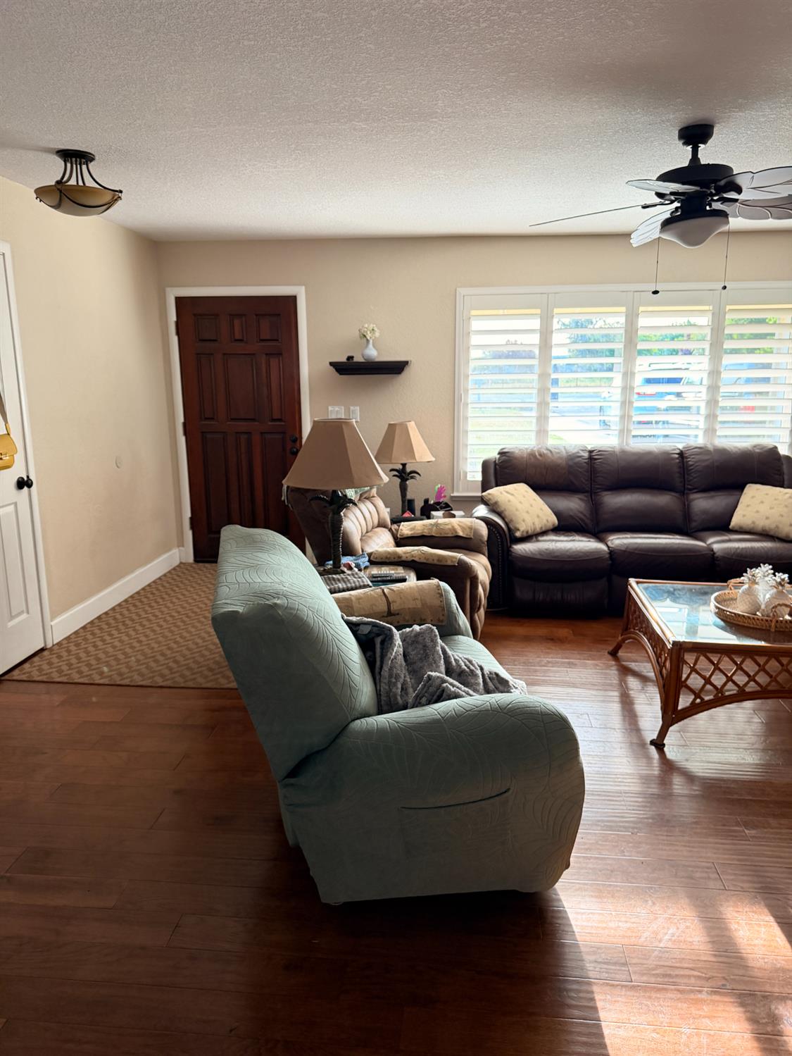 5645 20th Street Rio Linda, CA 95673 - Photo 27 of 69 living room with ceiling fan, wood-type flooring, and a textured ceiling, plantation shutters