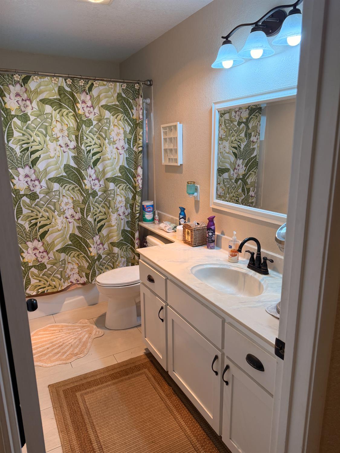 5645 20th Street Rio Linda, CA 95673 - Photo 38 of 69 full bath with vanity, a textured wall, light tile patterned floors, and shower / bath combination with window