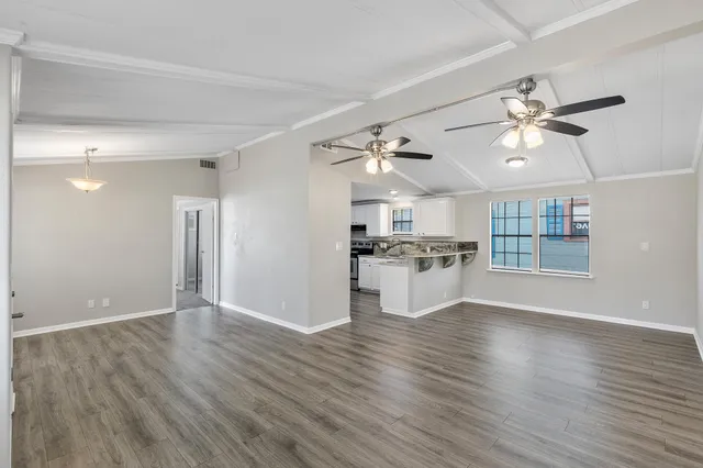 a view of kitchen with granite countertop cabinets and wooden floor