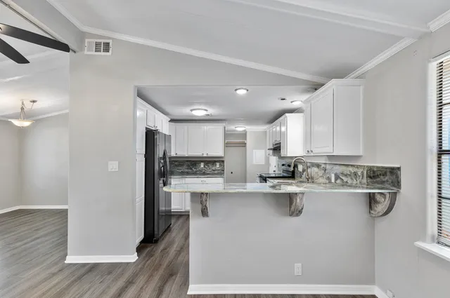 a kitchen with stainless steel appliances a sink stove and refrigerator