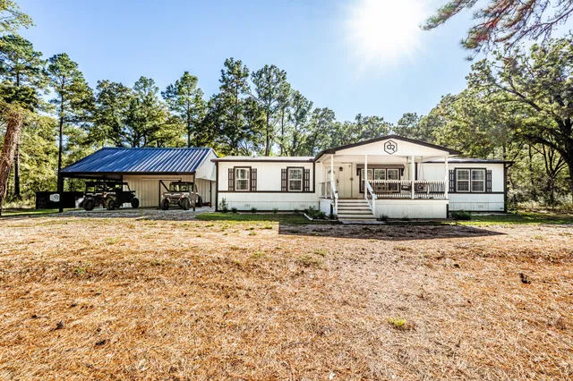 a living room with furniture and view of kitchen