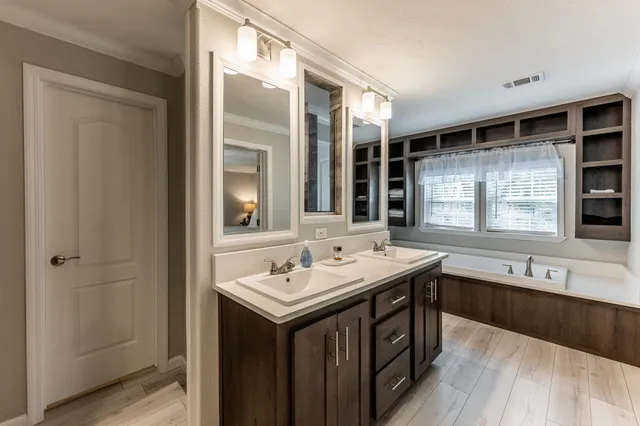 a bathroom with a double vanity sink and a mirror