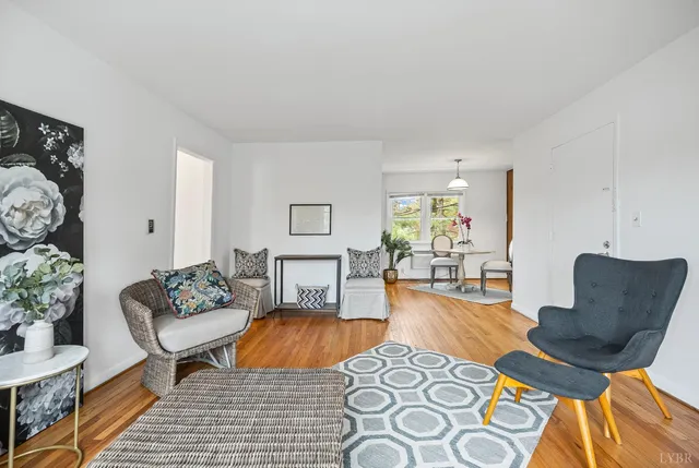 a living room with furniture and wooden floor