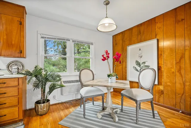 a living room with patio furniture and a potted plant