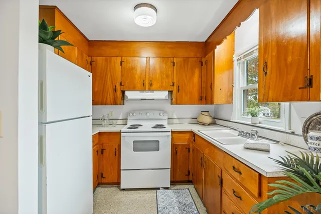 a kitchen with a sink and a refrigerator