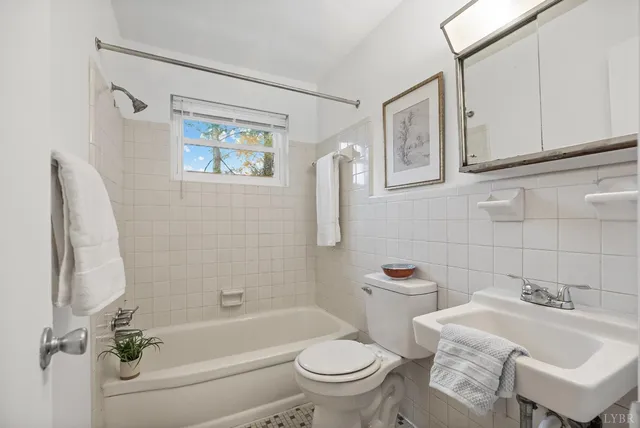 a bathroom with a sink a toilet and bathtub