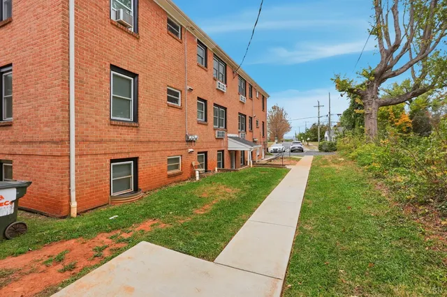 a large building with a yard in front of it