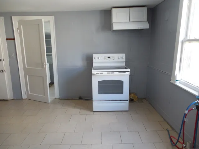 a view of workspace with window and cabinet