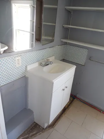 a bathroom with a white toilet and bathtub
