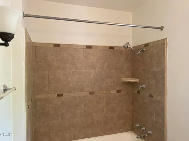 a bathroom with a shower and a sink