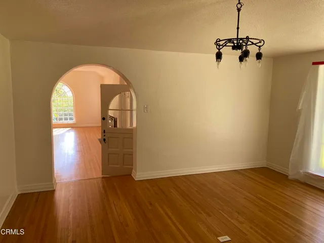 a view of a room with wooden floor closet and windows