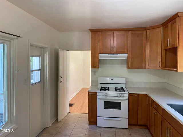 a kitchen with a stove and a refrigerator