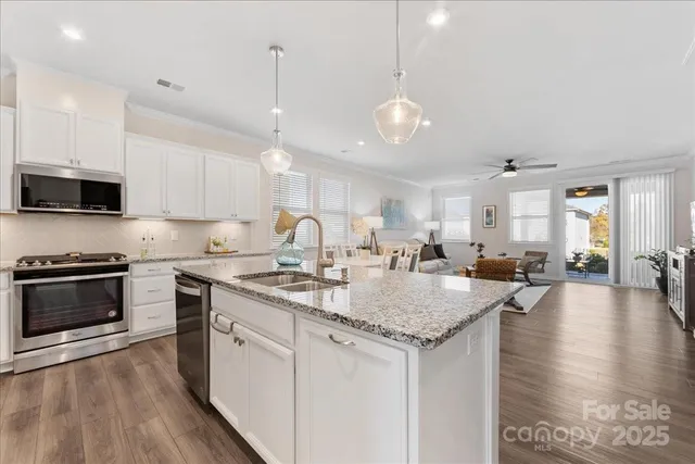 a kitchen with a table chairs stove and cabinets