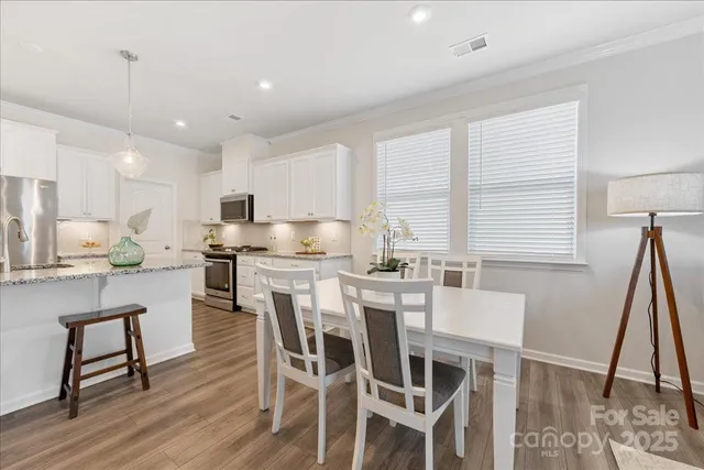 a view of a dining room with furniture window and wooden floor