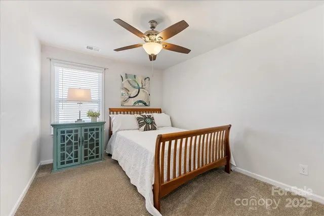an empty room with a window and a ceiling fan