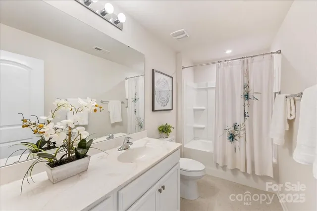 an empty room with a chandelier fan and closet