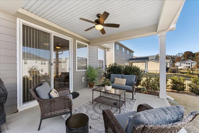 a balcony with furniture and a potted plant
