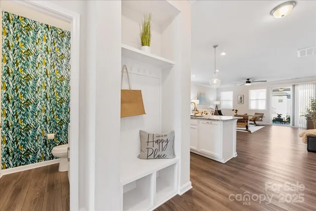 a living room with furniture and a kitchen view