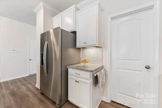 a kitchen with a refrigerator sink and cabinets