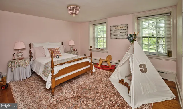 a bedroom with two beds and painting on the wall