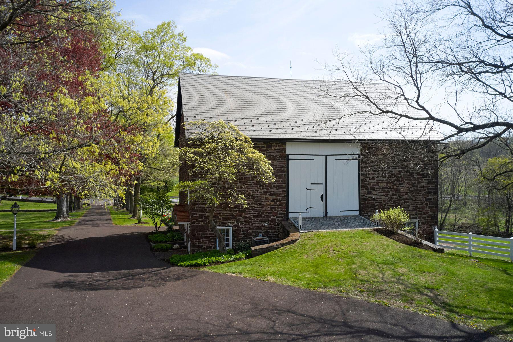 6398 Durham Road Pipersville, PA 18947 - Photo 56 of 68 a front view of a house with a yard and trees