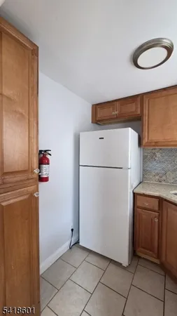 a kitchen with a stove a sink and a refrigerator