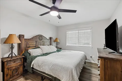 a bedroom with bed and flat tv screen on dresser