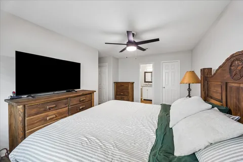 a bedroom with a bed and a flat screen tv