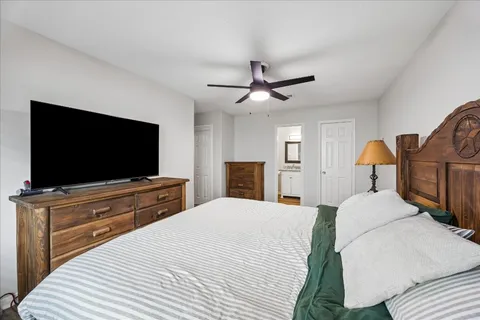 a bedroom with a bed and a flat screen tv