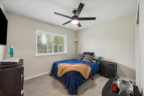 a bedroom with a bed and a window