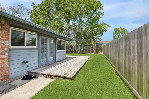 a view of backyard with a small cabin and wooden fence