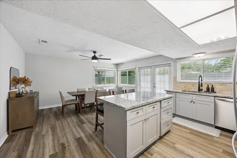 a kitchen with sink stove and white cabinets
