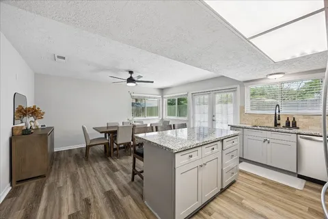 a kitchen with sink stove and white cabinets