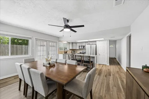 a view of a dining room with furniture and window
