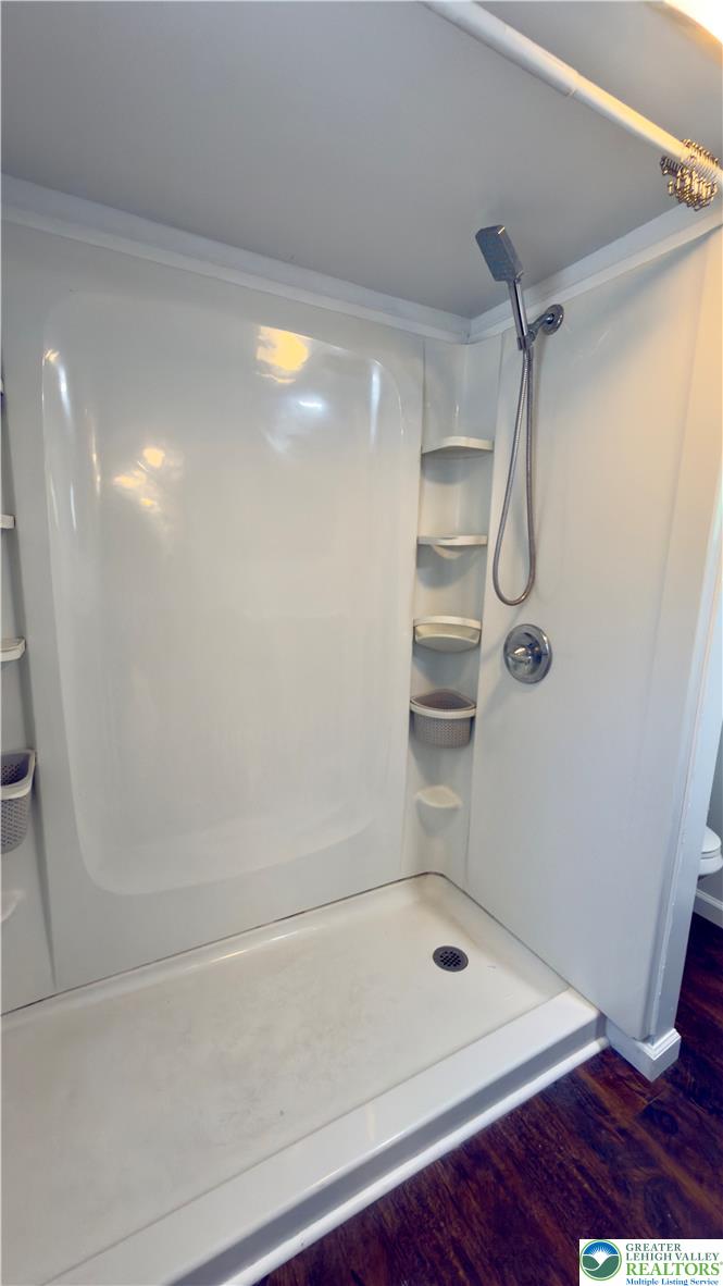 246 Poplar Street Bath, PA 18014 - Photo 32 of 34 Streamlined shower unit provides efficient bathing with integrated shelving for convenience.