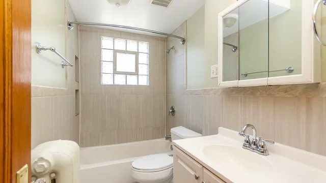 a view of a room with wooden floor and white walls
